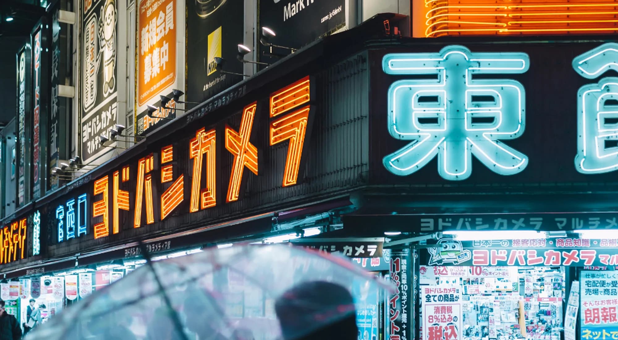 A DKN team member looking out over a city lit by digital screens
