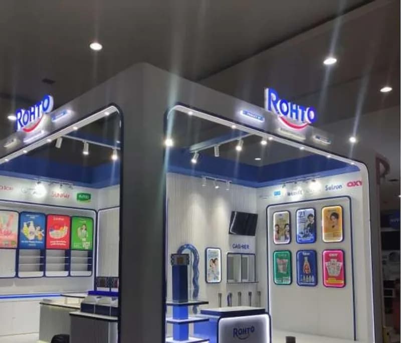 A Rohto retail booth with illuminated logos and backlit product panels