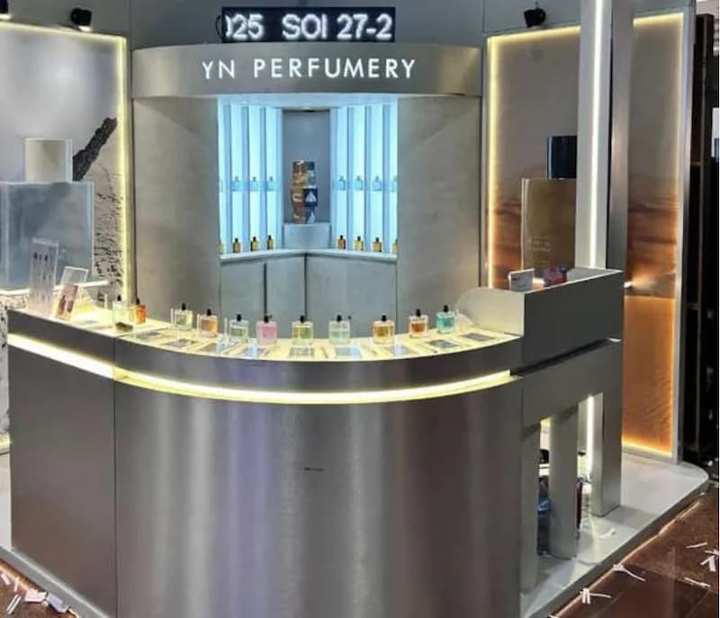 A curved brushed-metal perfume counter for YN Perfumery